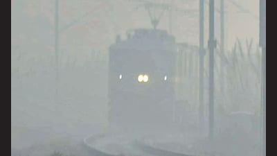 A train approaches at Masuri amid dense smog in Ghaziabad on Wednesday. (Sakib Ali)