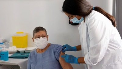 A tourist receives a coronavirus disease (Covid-19) vaccination at a mobile vaccination point installed by Spain's Valencia Health Ministry. (REUTERS)