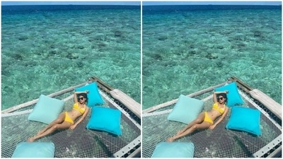 In a yellow bikini, Mouni posed with pillows around and gave us fresh vacay goals. (Instagram/@imouniroy)