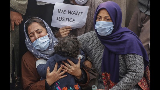 The wife of Mudasir Gul, one of the civilians killed during an encounter with suspected militants at Hyderpora, holds their daughter and demands for justice and the return of her husband's body during a protest in Srinagar on Wednesday. (Waseem Andrabi/HT)