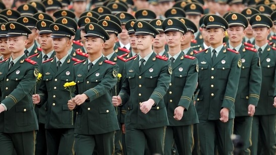 Members of China’s People’s Liberation Army (PLA) prepare to lay flowers at the Monument to the People’s Heroes during a ceremony on Tiananmen Square to mark Martyrs Day, in Beijing, China on September 30, 2021. The Chinese military has conducted “major operations related to border defence” and strengthened training under combat conditions to build a modern armed force, the ruling Communist Party of China has said. (REUTERS)