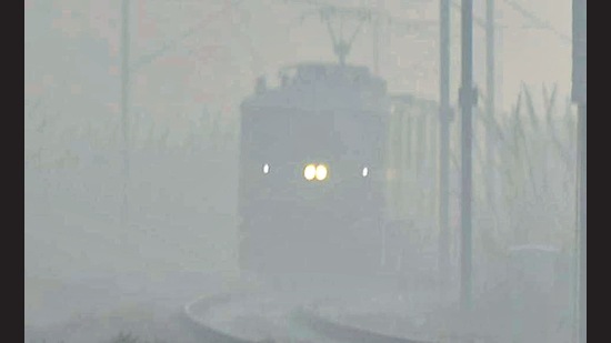 A train approaches at Masuri amid dense smog in Ghaziabad on Wednesday. (Sakib Ali)