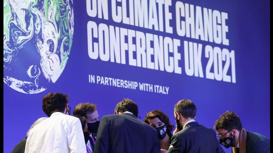 Delegates talk during the UN Climate Change Conference (COP26) in Glasgow, Scotland, November 13, 2021 (REUTERS)