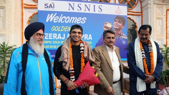 Olympic Gold medalist Javelin thrower Neeraj Chopra along with SAI NIS Senior Executive Director Colonel Raj Singh Bishnoi (2nd from right) and other dignitaries in a group picture during a felicitation ceremony, at NSNIS, in Patiala on Wednesday.(ANI)