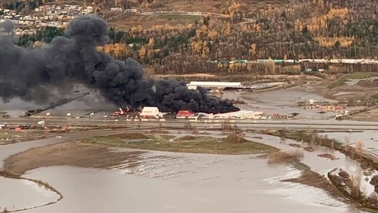 Vehicle holding lot on fire surrounded by flood waters in Abbotsford, British Columbia, Canada, November 17, 2021.&nbsp;(REUTERS)