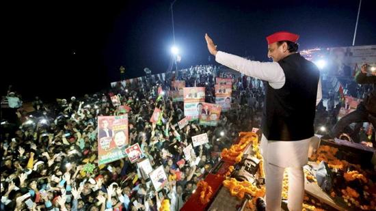 Samajwadi Party chief Akhilesh Yadav waves to supporters during the Vijay Yatra in Ambedkarnagar district of Uttar Pradesh. (PTI PHOTO)