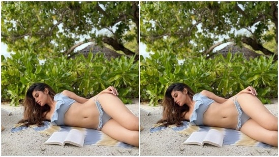 This is from Mouni’s Maldives vacation when she posed with a book on the sand.(Instagram/@imouniroy)