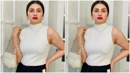 Prachi accessorised her look for the day with a sleek ivory white sling bag with gold chains.(Instagram/@prachidesai)