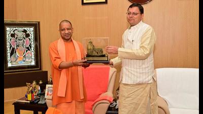 Uttar Pradesh chief minister Yogi Adityanath being felicitated with a miniature model of a temple by Uttarakhand chief minister Pushkar Singh Dhami, in Lucknow on Thursday. (ANI Photo) Uttar Pradesh chief minister Yogi Adityanath being felicitated with a miniature model of a temple by Uttarakhand chief minister Pushkar Singh Dhami, in Lucknow on Thursday. (ANI Photo)