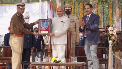 UT administrator Banwarilal Purohit and Chandigarh director general of police Praveer Ranjan during the 55th Raising Day parade in Sector 26 on Thursday. (HT Photo)