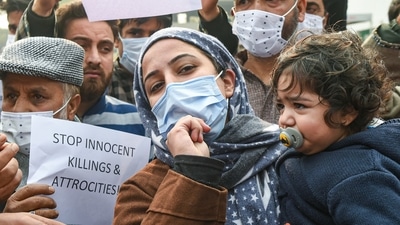 Families members of Altaf Ahmad Bhat and Mudasir Gul, shout slogans and hold placards during a protest demanding a probe and return of the dead bodies, in Srinagar on November 17, 2021. (PTI) Families members of Altaf Ahmad Bhat and Mudasir Gul, shout slogans and hold placards during a protest demanding a probe and return of the dead bodies, in Srinagar on November 17, 2021. (PTI)
