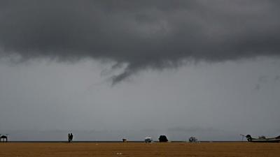 Dark clouds are seen over Marina beach in Chennai, Tamil Nadu, on Wednesday. (AFP)