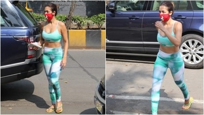 The 46-year-old embraced tropical vibes with the print, which was a mixture of black, green, white, and turquoise shades. For the yoga session, Malaika chose to go sans jewellery with the separates. She picked a pair of neon green slides and a red printed face mask for accessories. (HT Photo/Varinder Chawla) The 46-year-old embraced tropical vibes with the print, which was a mixture of black, green, white, and turquoise shades. For the yoga session, Malaika chose to go sans jewellery with the separates. She picked a pair of neon green slides and a red printed face mask for accessories. (HT Photo/Varinder Chawla)