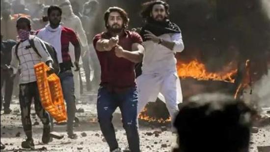 Photos of Pathan pointing a gun at head constable Deepak Dahiya were widely on social media and he was arrested on March 3, 2020. (Sourced)
