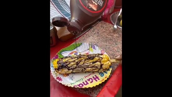 The corn cob being generously drizzled with Hershey's chocolate sauce. (instagram/@anikaitluthra) The corn cob being generously drizzled with Hershey's chocolate sauce. (instagram/@anikaitluthra)