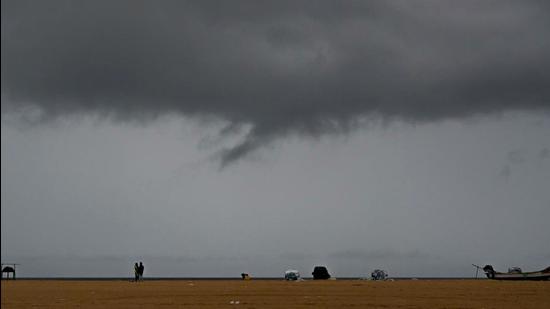 Dark clouds are seen over Marina beach in Chennai, Tamil Nadu, on Wednesday. (AFP)