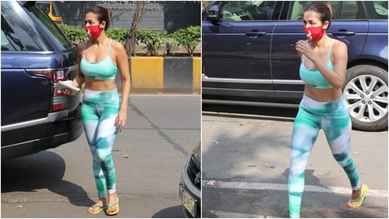 The 46-year-old embraced tropical vibes with the print, which was a mixture of black, green, white, and turquoise shades. For the yoga session, Malaika chose to go sans jewellery with the separates. She picked a pair of neon green slides and a red printed face mask for accessories.&nbsp;(HT Photo/Varinder Chawla)