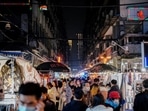 The origins of the Sars-CoV-2 virus, which causes Covid-19 remains a mystery, and a major source of tension between China and several western countries. In picture - People visit a street market almost a year after Covid in Wuhan, China.