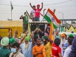 Protesters at the Tikri border celebrate the PM's announcement that the farm laws will be repealed.