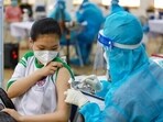 A student receives a Pfizer vaccine jab at Cu Chi district in Ho Chi Minh City, Vietnam due to Covid-19 (Thu Huong/VNA via AP)