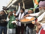 Farmers celebrate Centre's decision to repeal farm laws with jalebis at Ghazipur border.