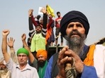 Farmers celebrate at Delhi’s Singhu border protest site after PM Narendra Modi announced that the three contentious farm laws will be repealed. (Sanchit Khanna/ Hindustan Times)