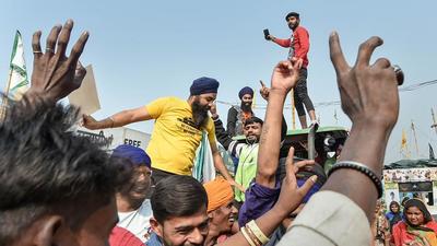 Farmers celebrate at Delhi’s Singhu border after Prime Minister Narendra Modi announced the three farm laws will be repealed, on Friday. (PTI) Farmers celebrate at Delhi’s Singhu border after Prime Minister Narendra Modi announced the three farm laws will be repealed, on Friday. (PTI)