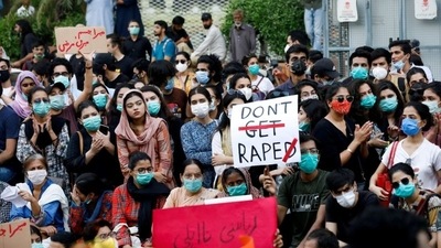 People carry signs against rising cases of rape in Pakistan (REUTERS)