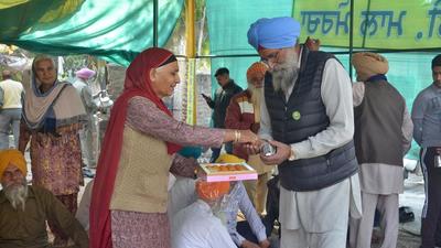 Commuters, including truck drivers, police men and passersby, stopped at the Ladowal protest site to hug and congratulate the farmers for their landmark victory at the Ladowal Toll Plaza. (Gurpreet Singh/HT)