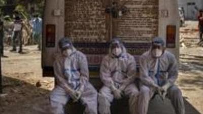 Exhausted workers, who bring dead bodies for cremation, sit on the rear step of an ambulance inside a crematorium in New Delhi. (AP File Photo | Representational image) Exhausted workers, who bring dead bodies for cremation, sit on the rear step of an ambulance inside a crematorium in New Delhi. (AP File Photo | Representational image)