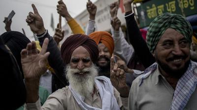 Farmers celebrate at a protest site on the Delhi-Haryana border crossing in Singhu, in New Delhi on Friday. Prime Minister Narendra Modi announced that the Centre would scrape the three farm laws ahead of crucial state elections. (Bloomberg) Farmers celebrate at a protest site on the Delhi-Haryana border crossing in Singhu, in New Delhi on Friday. Prime Minister Narendra Modi announced that the Centre would scrape the three farm laws ahead of crucial state elections. (Bloomberg)