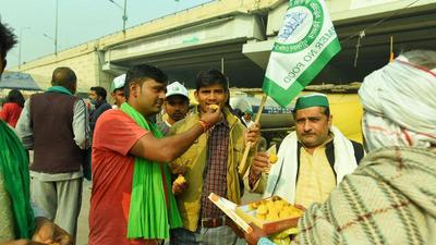 Farmers celebrating after Prime Minister Narendra Modi announced the repeal of the farm laws on Friday even as their agitation is set to complete a year on the borders of the national capital, Delhi. (Raj K Raj/HT) Farmers celebrating after Prime Minister Narendra Modi announced the repeal of the farm laws on Friday even as their agitation is set to complete a year on the borders of the national capital, Delhi. (Raj K Raj/HT)