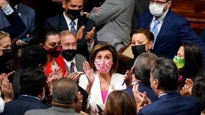 Speaker of the House Nancy Pelosi celebrates the House passage of President Joe Biden's expansive social and environment bill with other Democrats in the House Chamber at the US Capitol in Washington on Friday. (File Photo / AP) Speaker of the House Nancy Pelosi celebrates the House passage of President Joe Biden's expansive social and environment bill with other Democrats in the House Chamber at the US Capitol in Washington on Friday. (File Photo / AP)