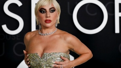 Lady Gaga glammed up her silver sequinned dress with standout make-up. She chose bold red lip shade, smoky eye shadow with silver accents, kohl-adorned eyes, OTT eyeliner, mascara-adorned lashes, blushed cheeks, and sharp contour. (REUTERS)