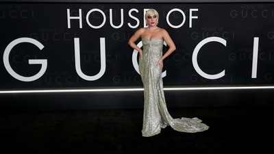 The bejewelled strapless dress featured a front slit on the neckline, gathered details on the bustier that flowed seamlessly into the attire, and a figure-sculpting silhouette that accentuated Gaga's hourglass frame. (REUTERS)
