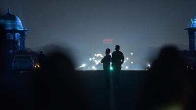 Low visibility due to a thick layer of smog at Vijay Chowk in New Delhi, Friday. (PTI)
