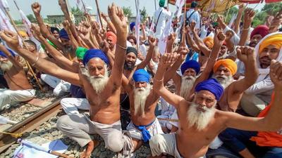 Farmers shout slogans while blocking a railway track during their protest against the farm laws, at Devi Dass Pura, in September last year. The farm laws were repealed by the Centre on Friday. (PTI) Farmers shout slogans while blocking a railway track during their protest against the farm laws, at Devi Dass Pura, in September last year. The farm laws were repealed by the Centre on Friday. (PTI)