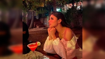 With a drink in front of her, and sitting aloof, Mouni Roy wondered if "the stars gaze back" at humans. (Instagram/@imouniroy) With a drink in front of her, and sitting aloof, Mouni Roy wondered if "the stars gaze back" at humans. (Instagram/@imouniroy)