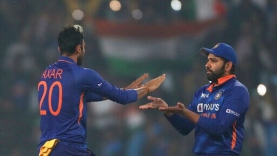 India's Axar Patel celebrates with captain Rohit Sharma the dismissal of New Zealand's Mark Chapman during the second T20 cricket match between India and New Zealand, in Ranchi, India, Friday, Nov. 19, 2021.(AP)