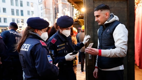 Austrian Chancellor Alexander Schallenberg said on Friday that the lockdown will start on Monday and initially last for 10 days. In picture - Police check vaccination status on a Christmas market in Vienna, Austria.(AP)