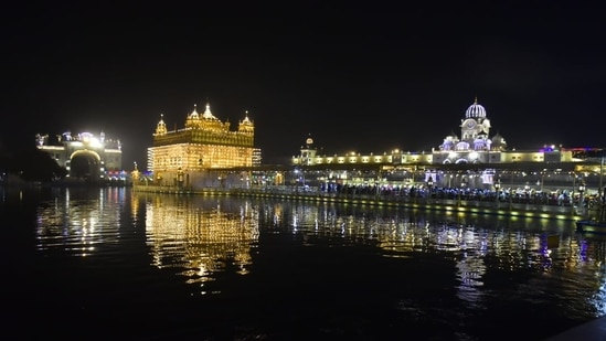 The festival is being celebrated with pomp in the Golden Temple, a preeminent spiritual site of Sikhism. Here's a view of the illuminated Golden Temple on the eve of the birth anniversary of Guru Nanak Dev.(Sameer Sehgal/Hindustan Times)