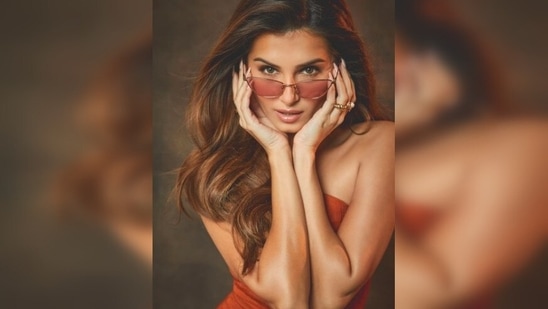 Sharing the photos, Tara Sutaria captioned her post, "Full of 🧡." She accessorised her look with a pair of cool tinted orange shades.(Instagram/@tarasutaria)