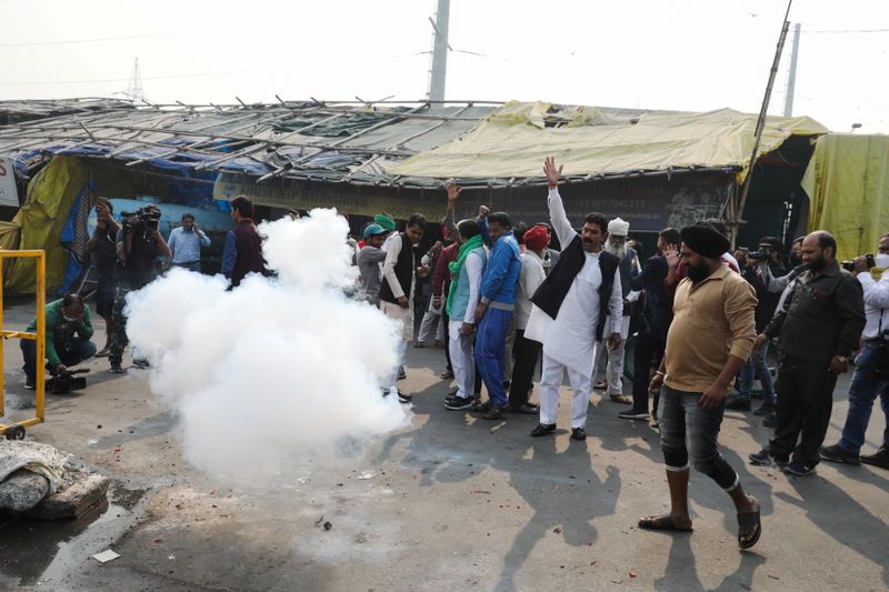 Farmers celebrate after Indian Prime Minister Narendra Modi announced that he will repeal the controversial farm laws, at the Ghazipur farmers protest site near Delhi-UP border. (REUTERS)