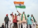 Bharatiya Kisan Union (BKU) spokesperson Rakesh Tikait waves a tri-colour flag at the Ghazipur border in New Delhi.