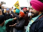 Farmers celebrate after Prime Minister Narendra Modi announced that he will repeal the controversial farm laws, at the Singhu border on Friday.