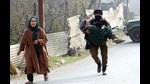 Army soldiers take an elderly woman to a safety place from an encounter site, at Ashmuji, in Kulgam, Kashmir, on Saturday. The district commander of the Hizbul Mujahideen was killed in the Kulgam encounter. (ANI Photo) Army soldiers take an elderly woman to a safety place from an encounter site, at Ashmuji, in Kulgam, Kashmir, on Saturday. The district commander of the Hizbul Mujahideen was killed in the Kulgam encounter. (ANI Photo)