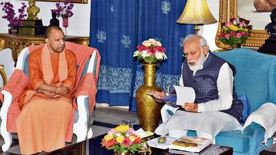 PM Narendra Modi with Uttar Pradesh CM Yogi Adityanath during a meeting at Raj Bhavan in Lucknow on Saturday. (PTI) PM Narendra Modi with Uttar Pradesh CM Yogi Adityanath during a meeting at Raj Bhavan in Lucknow on Saturday. (PTI)