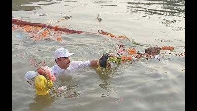 A day after Dev Deepawali, the cleaning of ghats and the water began by a group of volunteers. (HT Photo)