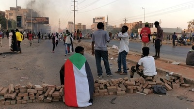 Sudanese anti-coup protesters barricade a road amid ongoing protests against last month's widely condemned military takeover, in the capital Khartoum (AFP) Sudanese anti-coup protesters barricade a road amid ongoing protests against last month's widely condemned military takeover, in the capital Khartoum (AFP)