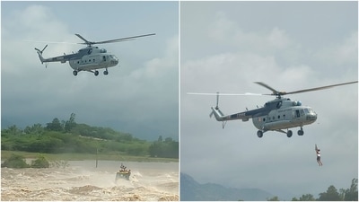 The Mi-17 helicopter can be seen carrying out winching operation to rescue people stranded on the top of a JCB machine. (@IAF_MCC) The Mi-17 helicopter can be seen carrying out winching operation to rescue people stranded on the top of a JCB machine. (@IAF_MCC)